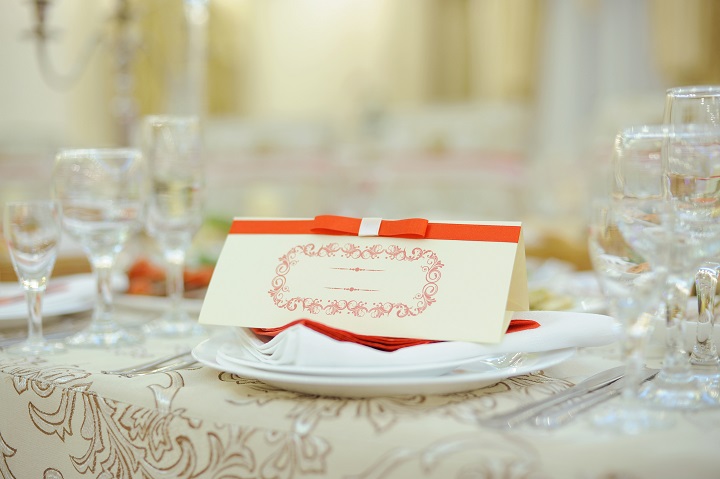 name card with red ribbon on plate